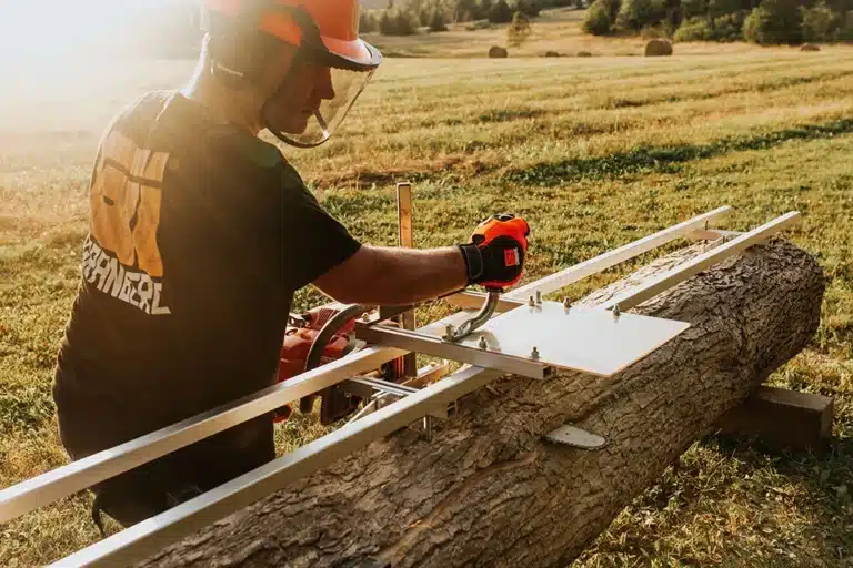 Carpenter operating sawmill on lumber